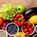 Healthy eating ingredients: fresh vegetables, fruits and superfood. Nutrition, diet, vegan food concept. Wooden background