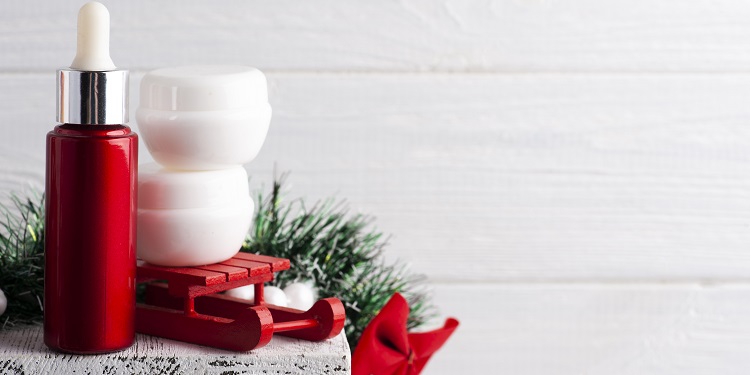 white jars red christmas composition with lit candle