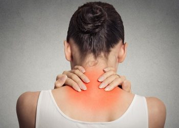 Healthy lifestyle. Back and spine disease. Closeup back view tired female massaging her neck colored in red isolated on gray background