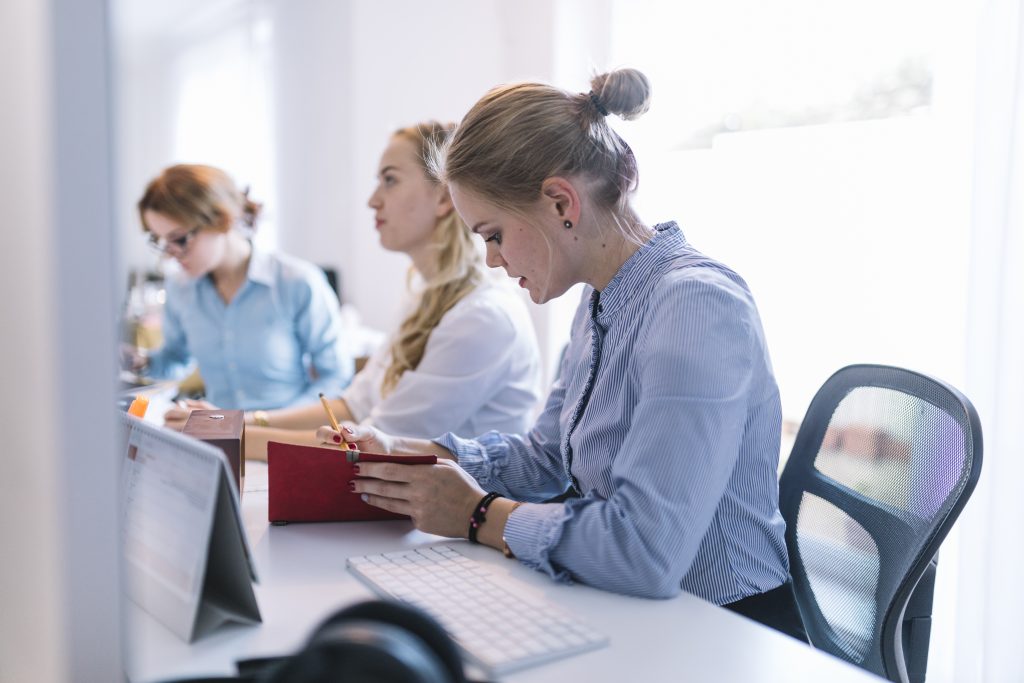 businesswomen sitting row working office