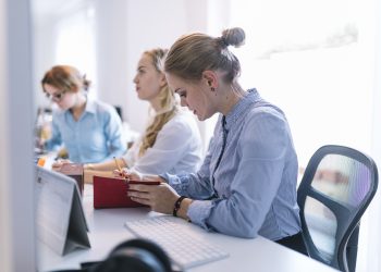 businesswomen sitting row working office