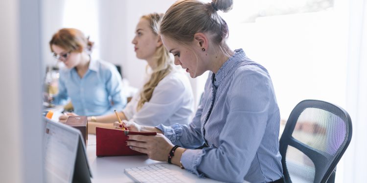 businesswomen sitting row working office